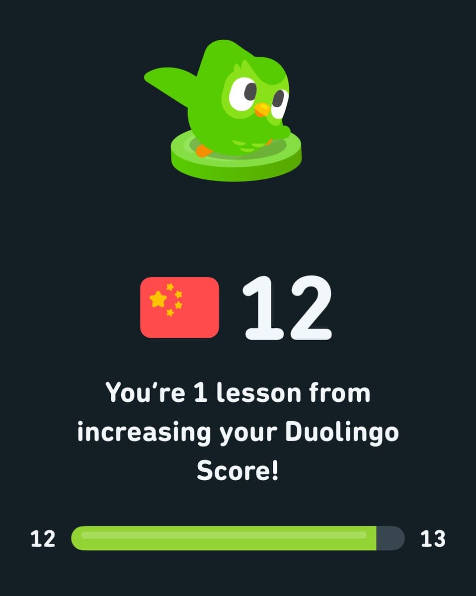 A screenshot from the Duolingo app showing a progress screen. It features the green Duolingo owl mascot, a Chinese flag icon, and a score of 12, with a progress bar indicating the user is close to reaching the next level.