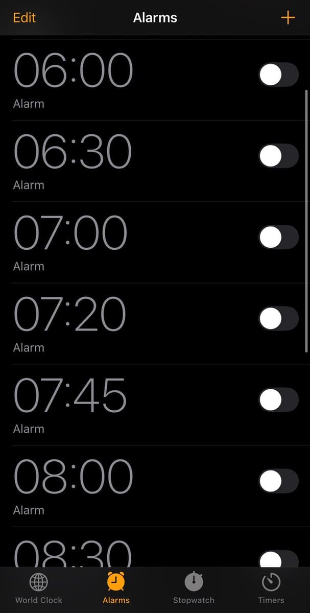 A screenshot of a smartphone's alarm settings screen, showing a list of disabled alarms. The interface is in dark mode, with a bottom navigation bar for World Clock, Alarms, Stopwatch, and Timers.