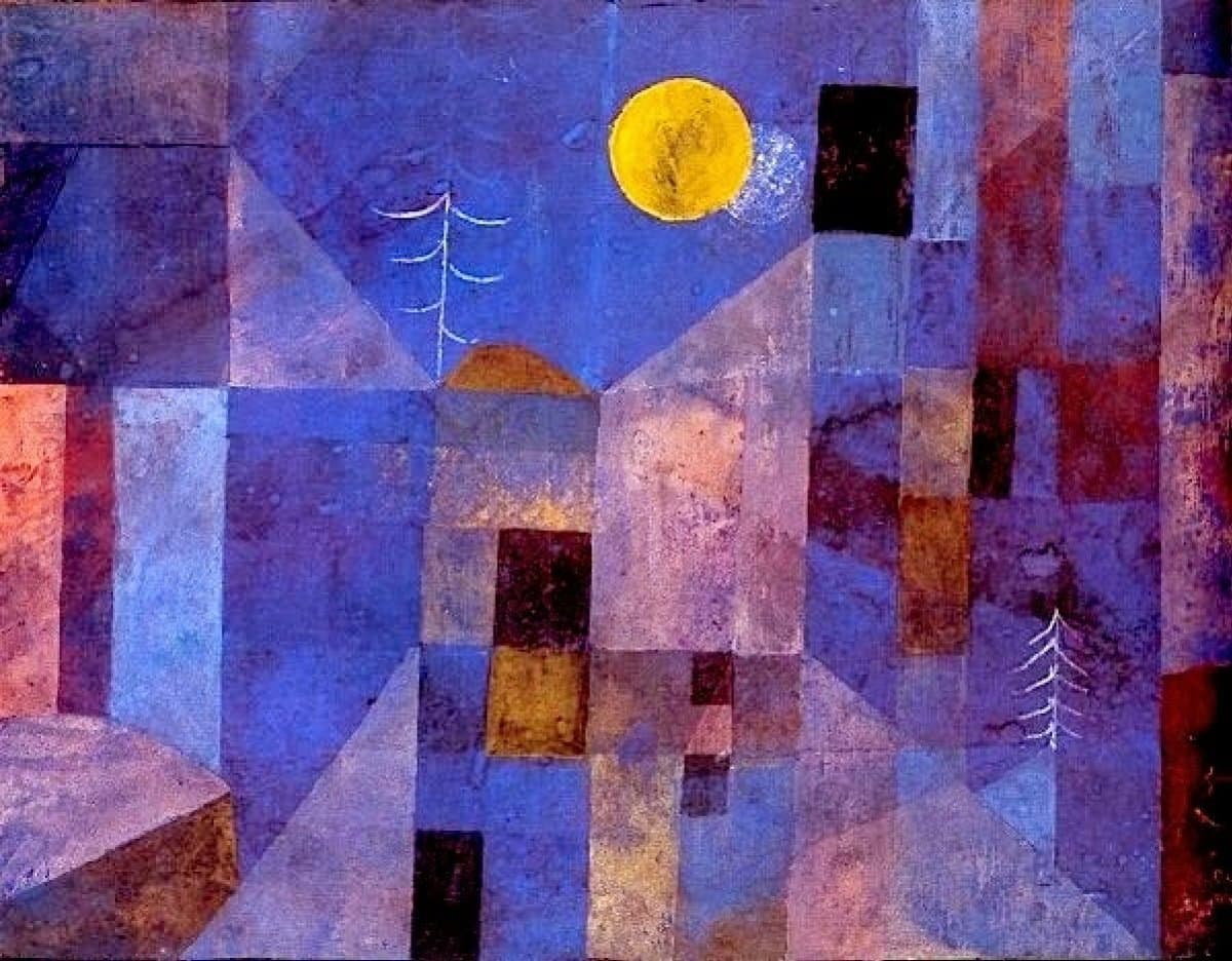 This is a reproduction of Paul Klee's 1919 painting "Moonshine," featuring a geometric, abstract landscape with a prominent yellow moon. The scene is composed of blocky, angular shapes in shades of blue, purple, and red, depicting stylized buildings and trees under a night sky.
