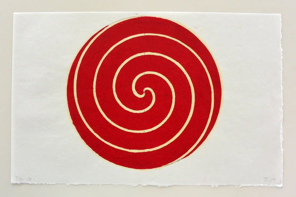 A woodblock print featuring a large red circle with a white spiral design on a white paper background. The print is signed and numbered in the bottom corners.